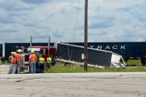 The tail end of an 18-wheeler was split open after a June 11 collision with a train on Texas 95, just north of the city.  Photo by  Niko Demetriou